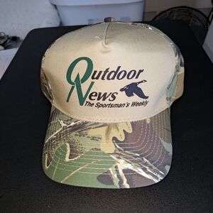 The Outdoor News The Sportsman's Weekly Camo Strap-on Hat Cap